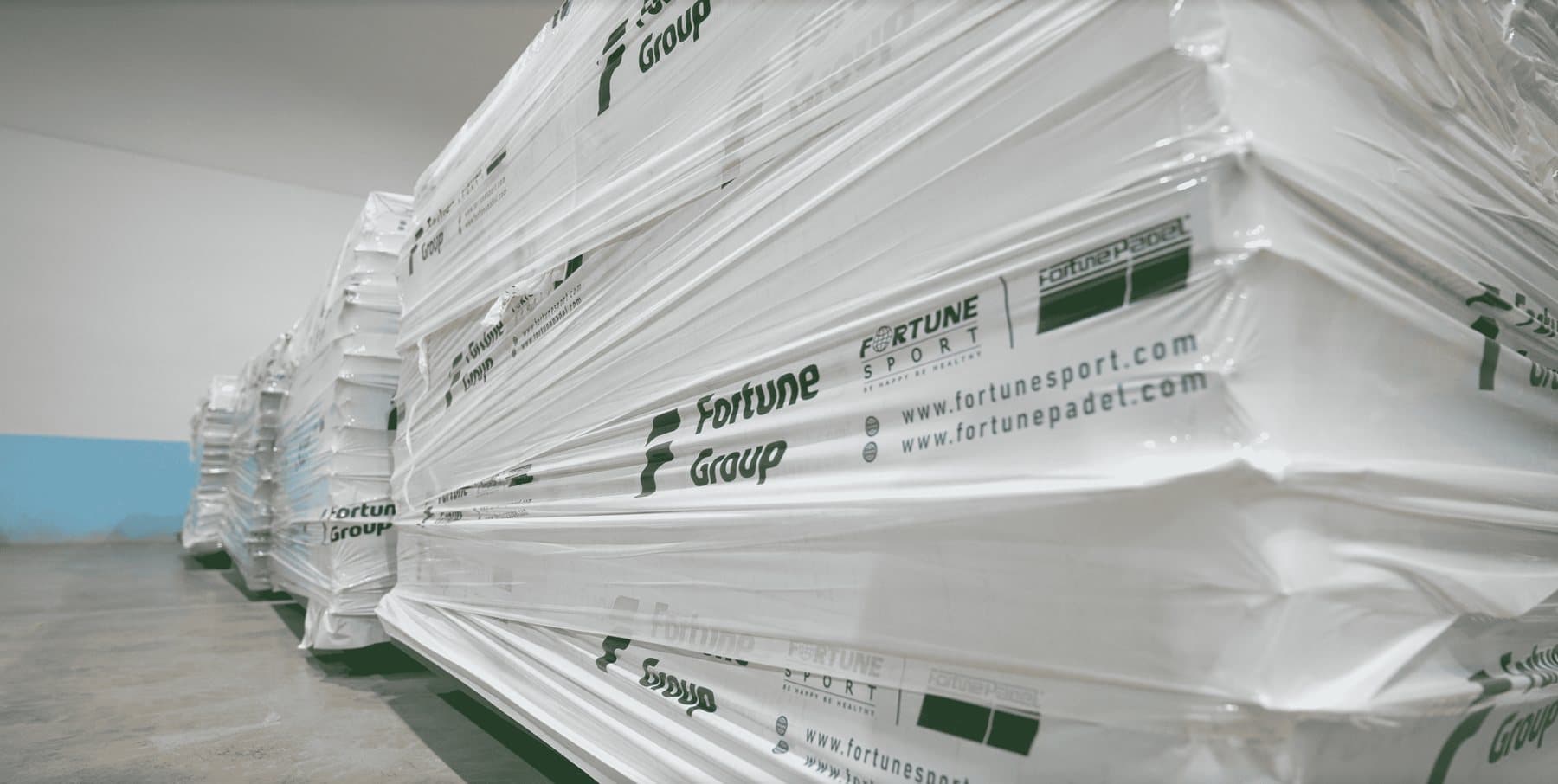 Pallets of padel court profiles packed and labelled Fortune Group in a warehouse